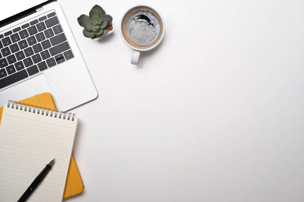 istock White office desk with laptop computer, coffee cup and notebook. Top view, Flat lay. 1397481105