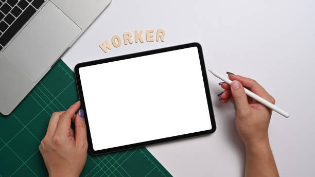 istock Female office worker holding stylus pen and writing on digital tablet. Above view. 1397481126