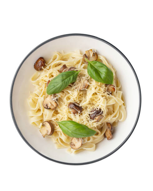 pasta with mushrooms, cheese and basil in a plate on a white background
