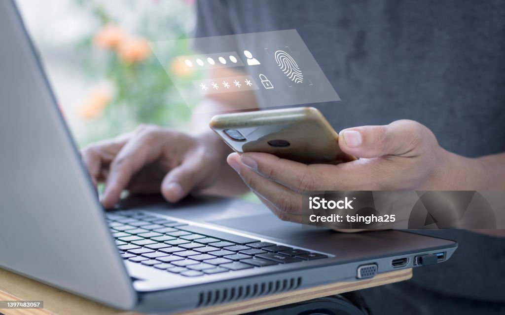 Two-step verification authorization for banking online, secure login access, SMS code security confirmation. man using laptop checking smartphone. Concept cyber security safe data protection business. Digital Authentication Stock Photo