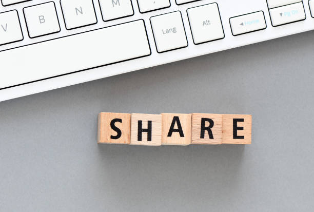 istock Word SHARE arranged from wooden letters on gray background. 1397483310