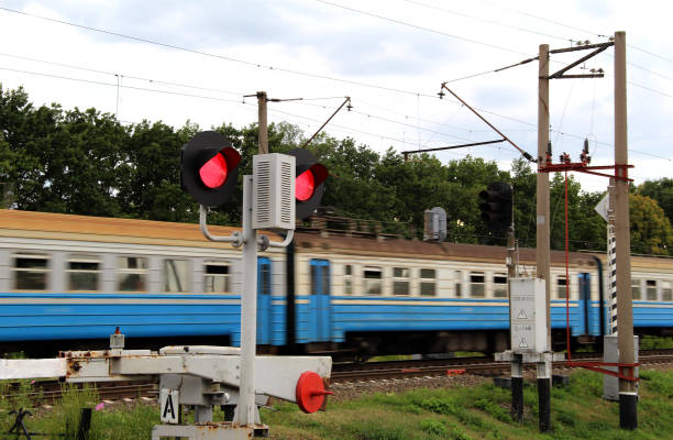 istock Train Car Passes A Closed Barrier At A Railway Crossing 1397483319