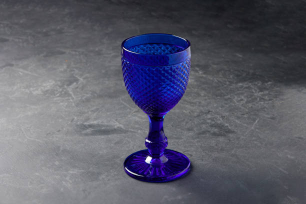 istock Elegant empty blue glass goblet on stone table closeup 1397483638
