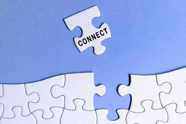 istock White jigsaw puzzle with word connect over blue background. 1397483783