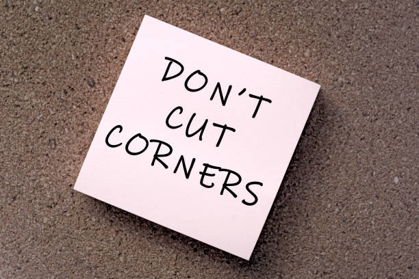 istock Don't cut corners message on sticky note against brown paper. 1397484453
