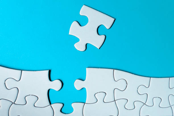 istock Piece of jigsaw puzzle on blue paper. Directly above. Copy space. 1397484521