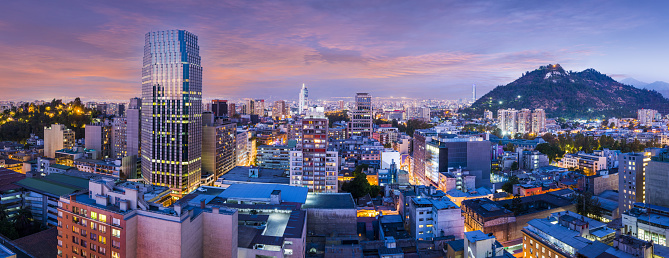 Santiago de Chile dwontown after sunset in a wide panoramic composition, Chile