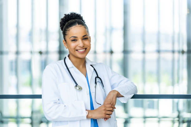 istock Cheerful female doctor in white coat smiling toward camera 1397485594