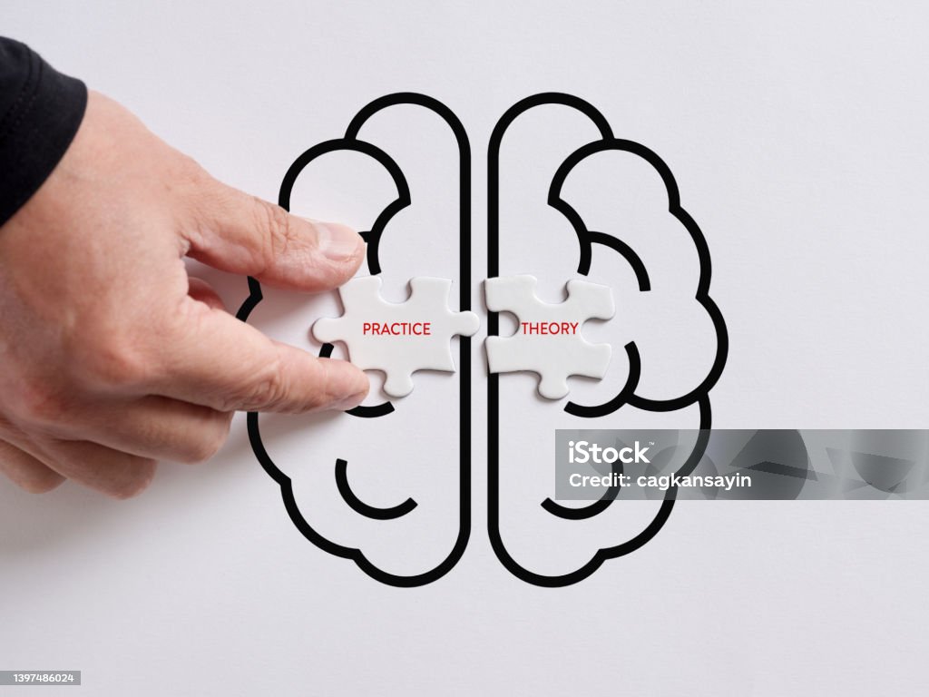Hand connects the puzzles with the words practice and theory on a human brain symbol. Hand connects the puzzles with the words practice and theory on a human brain symbol. To integrate practice and theory concept Resourceful Stock Photo