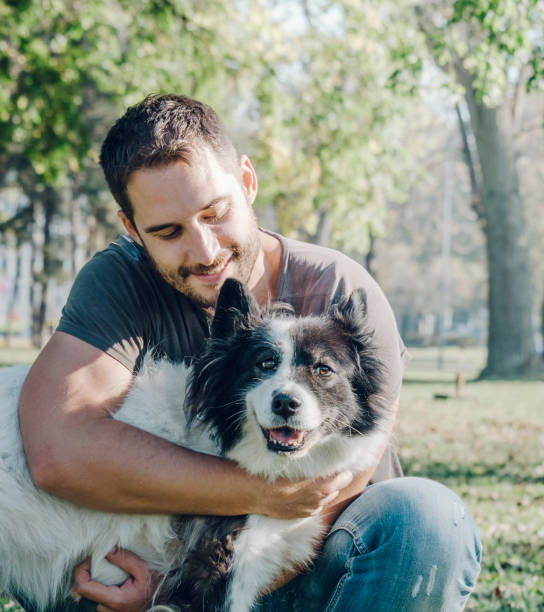 istock Man with his dog playing in the park 1397488582
