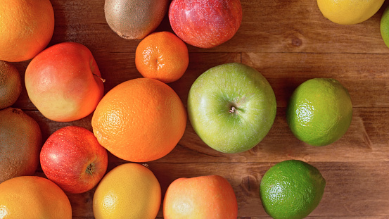 Close-up of various fresh fruits on wooden table.