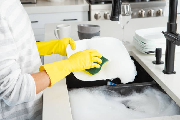 Hand washing dishes stock photo