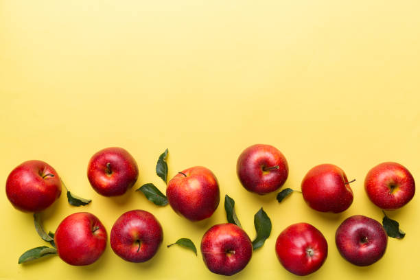 istock Many red apples on colored background, top view. Autumn pattern with fresh apple above view with copy space for design or text 1397489143