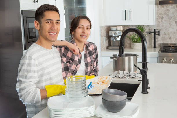 Sibling happily doing their chores stock photo