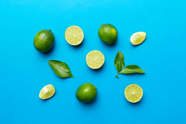istock Lime fruits with green leaf and cut in half slice isolated on white background. Top view. Flat lay with copy space 1397489191