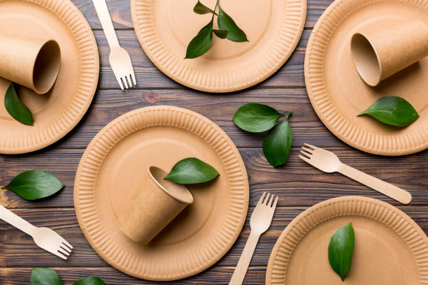 istock set of empty reusable disposable eco-friendly plates, cups, utensils on light white colored table background. top view. Biodegradable craft dishes. Recycling concept. Close-up 1397489197