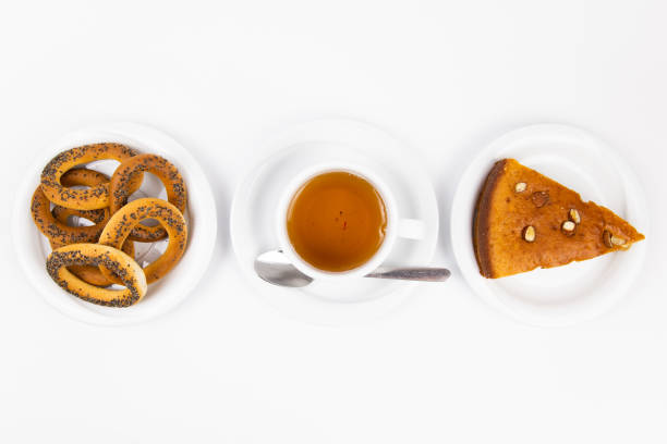 white tea set with teapot tea and saucers and pie for breakfast