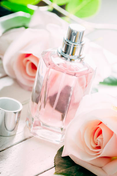 istock Perfume bottle and pink roses. 1397491950