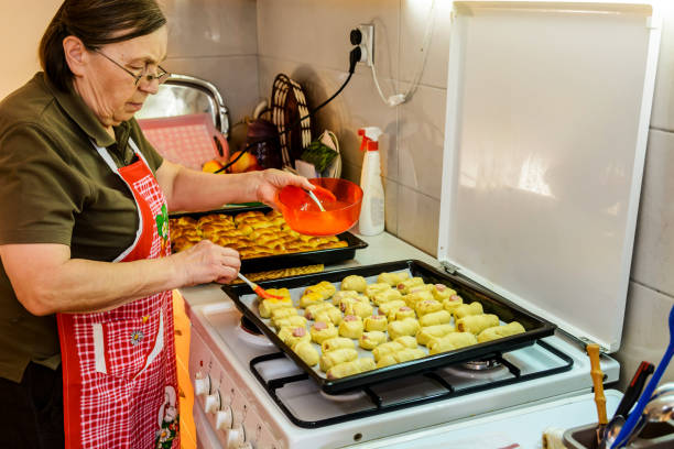 istock An older woman is preparing to make sausage rolls. 1397492831