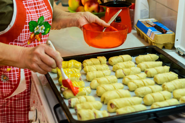 istock An older woman is preparing to make sausage rolls. 1397492889