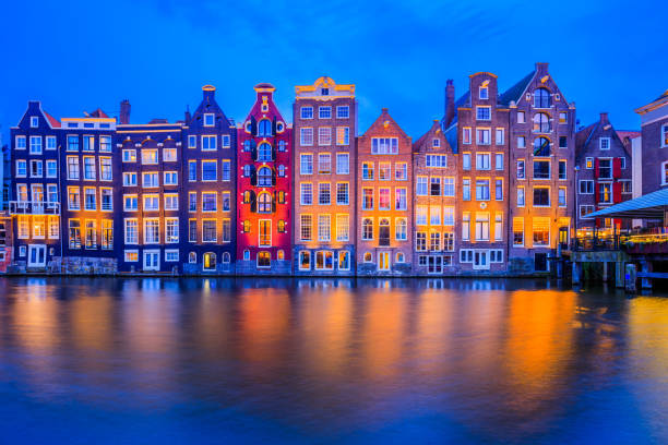 Amsterdam, Netherlands. Amsterdam, Netherlands. Colorful houses at the Damrak canal. canal house stock pictures, royalty-free photos & images