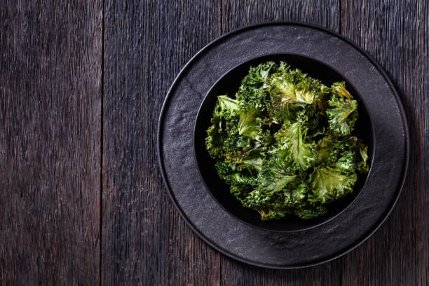 istock black bowl with kale chips on the table 1397495447
