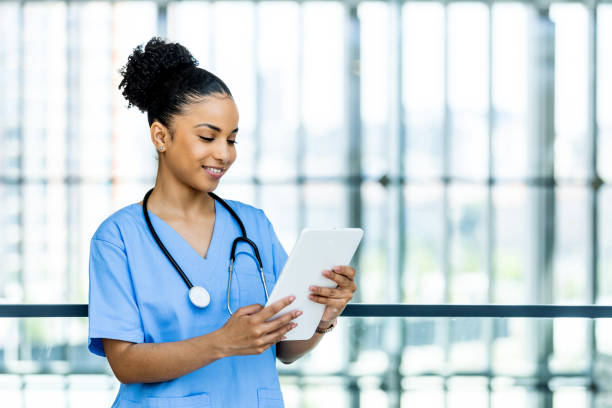 istock Attractive young nurse using a tablet while standing in her office during the day 1397495470