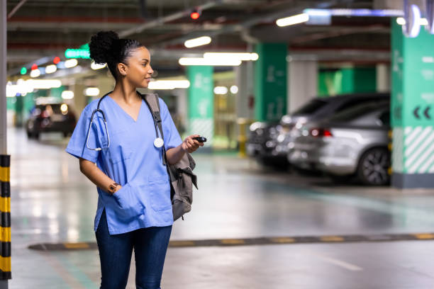 istock Woman unlocking a car by pressing on the remote control car alarm systems. 1397495517