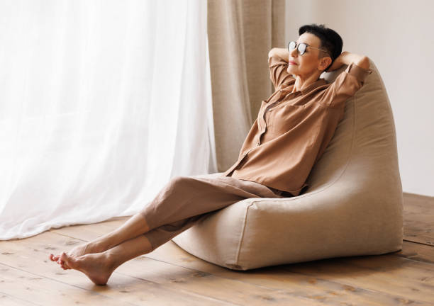 istock Relaxed mature female chilling near window 1397496747
