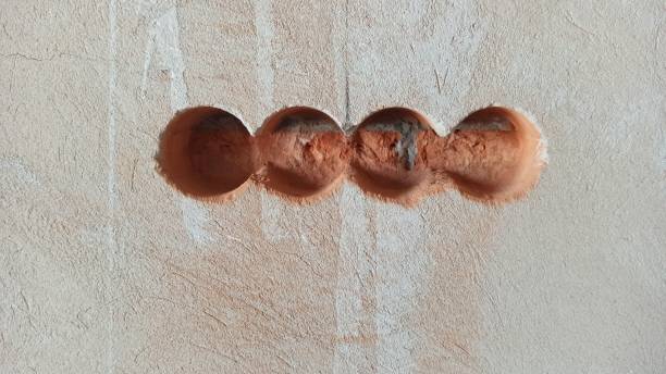 Holes for the electrical box on the plastered wall. Room renovation