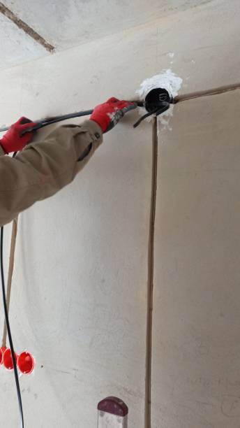 istock Installation of electrical wiring, electrical boxes, an electrician installs electrical wiring inside the building 1397498335