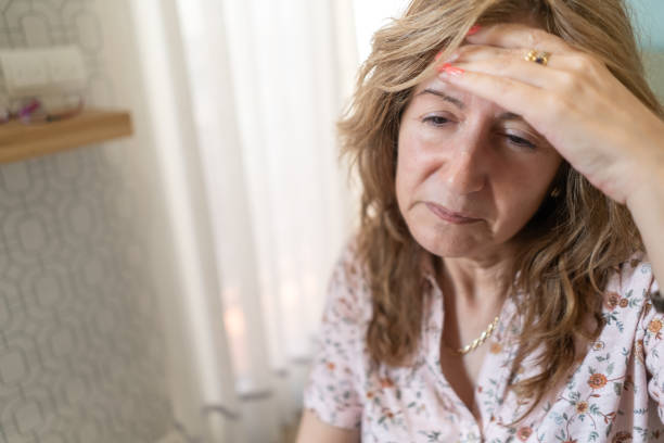 istock White woman with severe headache and with her hand on her forehead. 1397498358