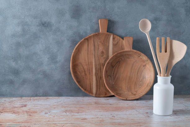 istock Modern kitchen kitchenware in light wood color with ladle, cutting boards and cookware on gray 1397499510