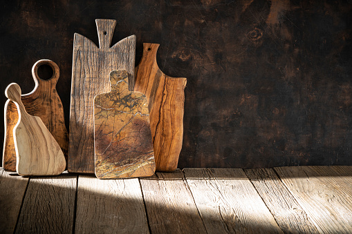 Rustic wooden cutting boards background with copy space ow wood vintage table board and light beam