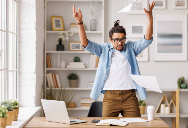 istock Furious black businessman throwing papers in home office 1397500664