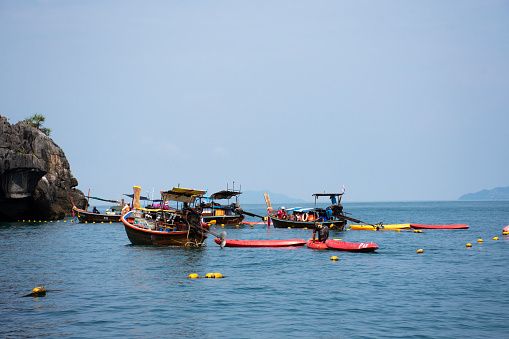 Local boat tour bring thai people travelers visit Ko Khao Yai and Prasat Hin Pan Yod and stop wait in sea ocean of Mu Ko Petra National Park in Pak Bara at La ngu on April 12, 2022 in Satun, Thailand