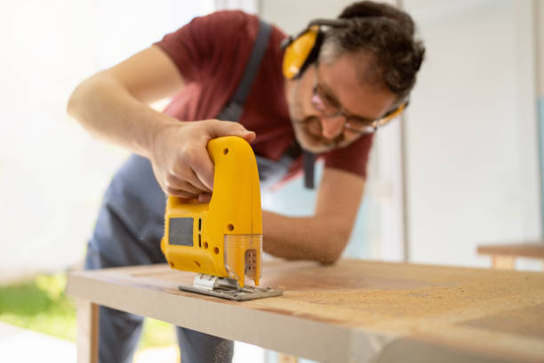 istock Male carpenter using jigsaw while making furniture 1397501895