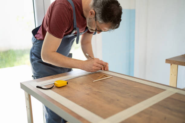 istock Caucasian carpenter measuring the kitchen countertop he working on kitchen countertop 1397502056