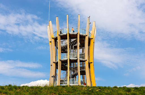 Elk, Poland - May 1, 2022: Modernistic sightseeing tower and platform over touristic promenade at Jezioro Elckie lake shore in Masuria region of Poland