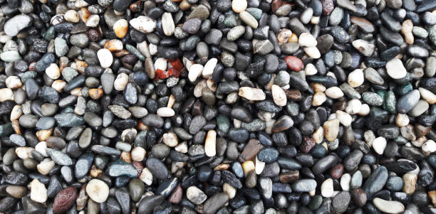 istock boulder pebble beach stones background seamless texture for design use, Naturally rounded gravel at sea shore Nature background texture pattern 1397502576