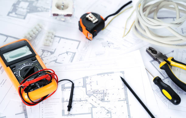 istock Making repairs,planning electricity project in house.Drawings,diagrams,plan for electrification of apartment, building. Devices and accessories, voltmeter, wires, screwdriver, pliers and tape measure 1397503552