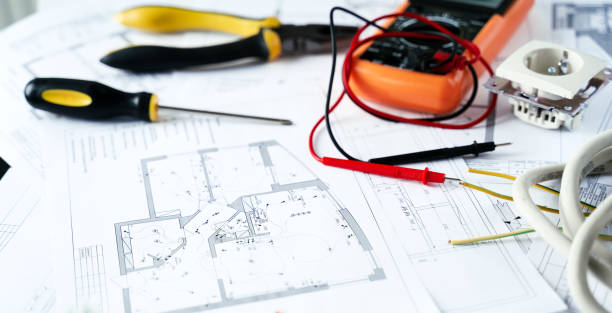 istock Making repairs,planning electricity project in house.Drawings,diagrams,plan for electrification of apartment, building. Devices and accessories, voltmeter, wires, screwdriver, pliers and tape measure 1397503554