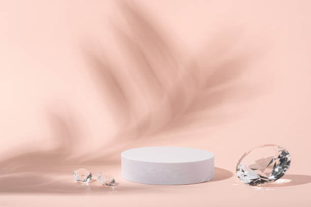 istock White podium with diamonds on a pink background. 1397503623