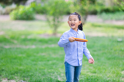 Little Girl Playing Frisbee