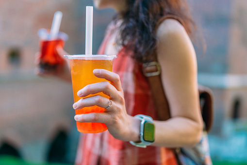 Tourist woman exploring Europe and enjoying bubble tea