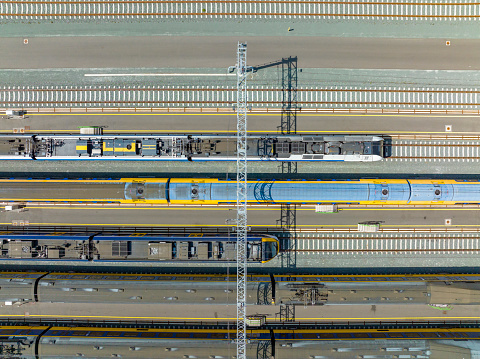 Railroad yard seen from above during a beautiful springtima day. Trains are stationary at the yard for various lines in Overijssel and Gelderland in The Netherlands.