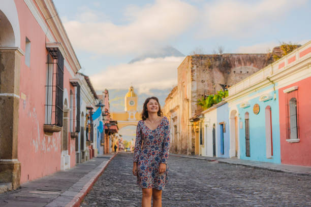 Woman walking in Antigua Young Caucasian woman in dress walking in Antigua, Guatemala guatemala landscape stock pictures, royalty-free photos & images
