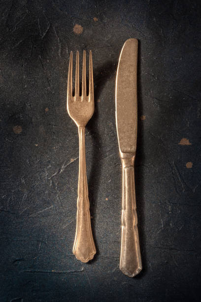 istock Elegant cutlery. A fork and a knife on a black slate background 1397506372