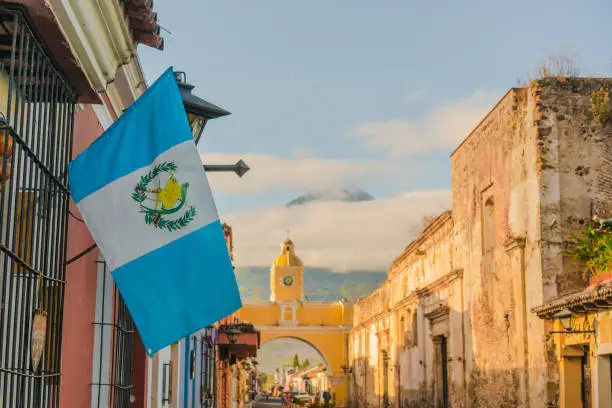 Photo of Antigua on the background of Agua volcano at sunrise