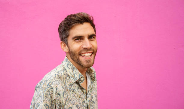 istock Laughing young man standing outside against a pink background 1397506561